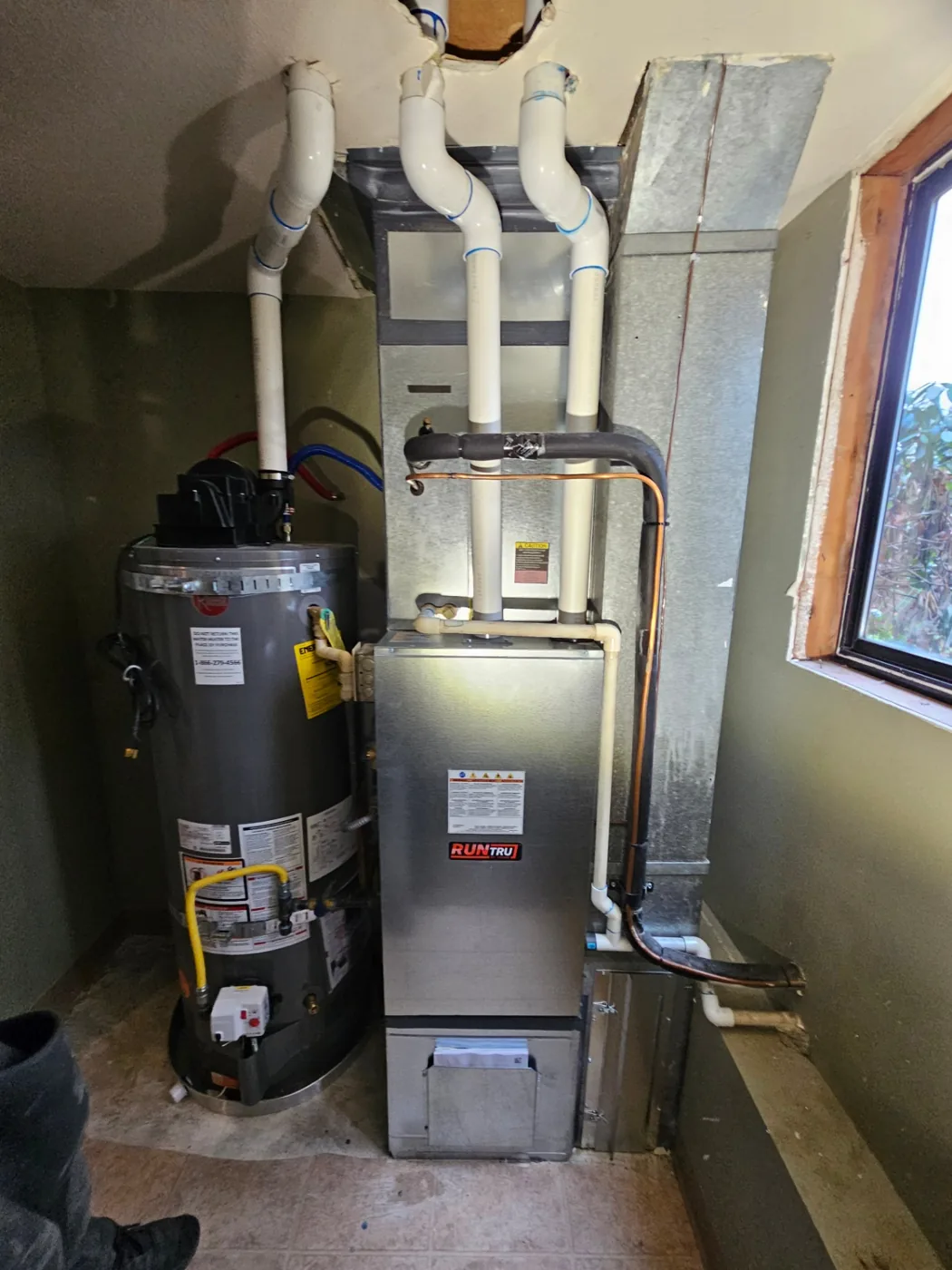 New Trane RunTru gas furnace and water heater installation in a Vancouver, Washington utility closet